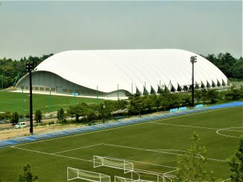 J-Village will soon be fully reopened. The white-roofed structure is an all-weather, year-round football training site.(July. 2018)